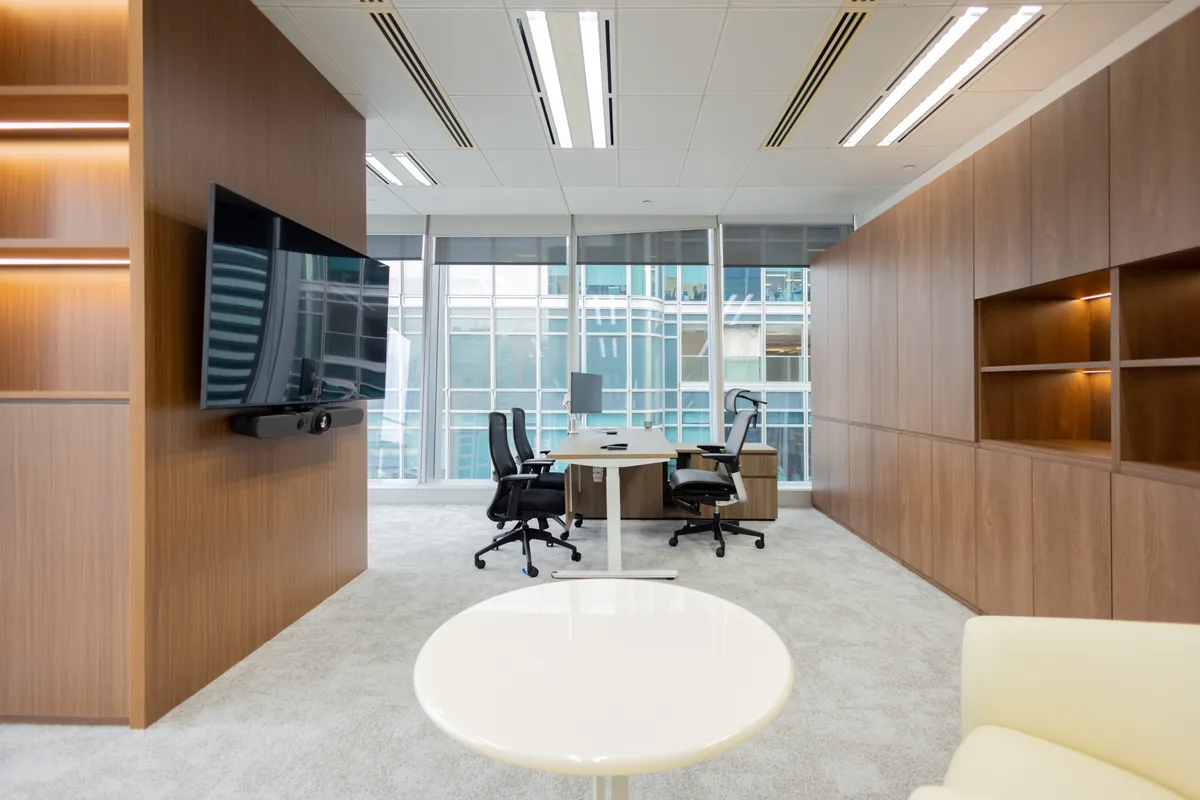 Executive Hong Kong office interior with polished finishes, meeting seating and focused work areas